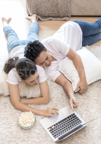 Couples lying down using laptop Stock photo © vichie81