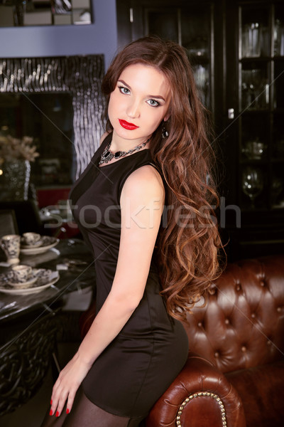 Elegant cute woman sitting on chesterfield armchair in luxury ro Stock photo © Victoria_Andreas