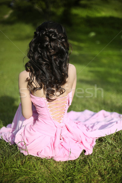 Brunette bride resting and sitting on green grass at spring park Stock photo © Victoria_Andreas