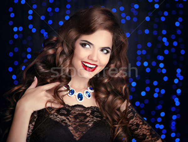 Beautiful happy smiling brunette girl with long shiny curly hair Stock photo © Victoria_Andreas