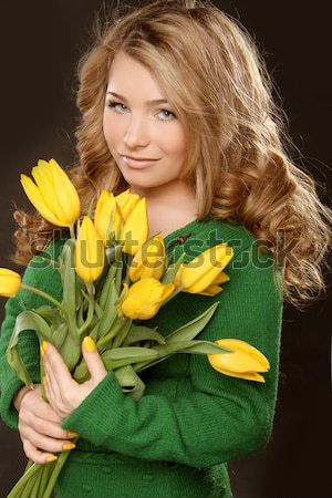 Happy smiling girl with spring-flowering yellow tulips isolated  Stock photo © Victoria_Andreas