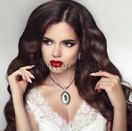 Healthy hair. Makeup. Beautiful brunette girl with long wavy hai Stock photo © Victoria_Andreas