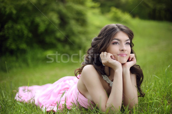 Attractive young teen girl with makeup wearing in pink dress lyi Stock photo © Victoria_Andreas