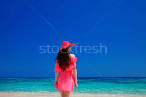 Brunette Woman enjoyng On Tropical Beach. Attractive girl in red Stock photo © Victoria_Andreas