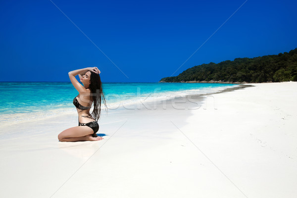 Sexy beautiful girl with long hair in black bikini relaxing on e Stock photo © Victoria_Andreas