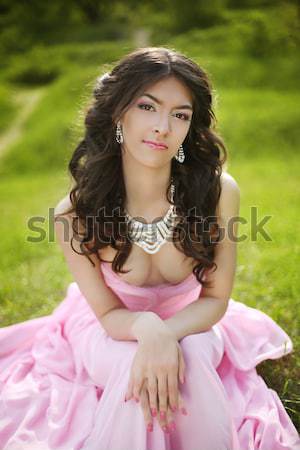 Brunette girl with flower chaplet wearing in pink dress at green Stock photo © Victoria_Andreas