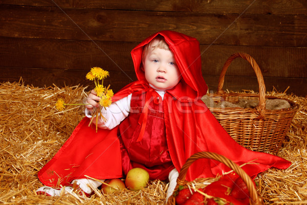 Cute little girl with dandelions wearing in red clothing resting Stock photo © Victoria_Andreas