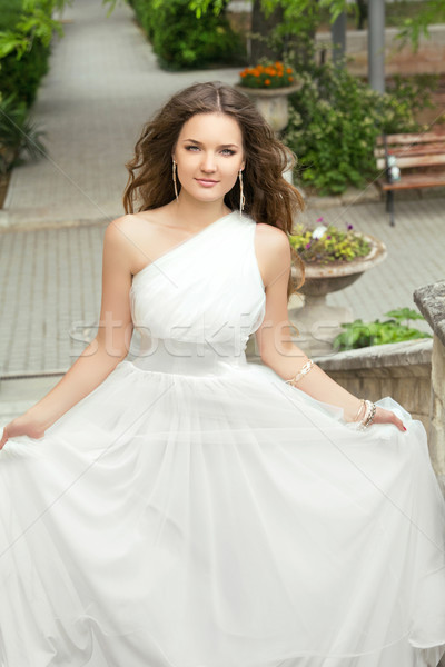 Attractive bride with long wavy hair in wedding dress with volum Stock photo © Victoria_Andreas