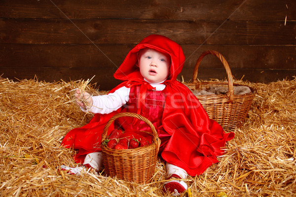 Funny girl is sitting on pile of straw with a basket. Little Red Stock photo © Victoria_Andreas
