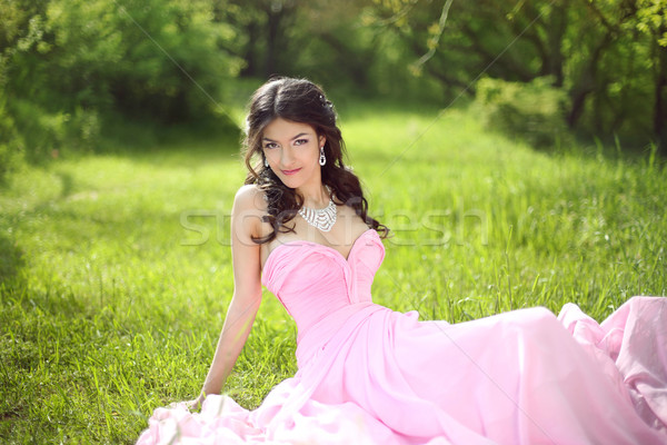 Happy smiling young bride girl dreaming and resting on green gra Stock photo © Victoria_Andreas