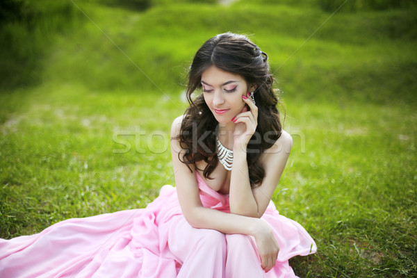 Attractive brunette young bride girl sitting on green grass at s Stock photo © Victoria_Andreas
