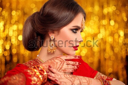 Makeup. Jewelry. Beautiful smiling woman model with expensive go Stock photo © Victoria_Andreas