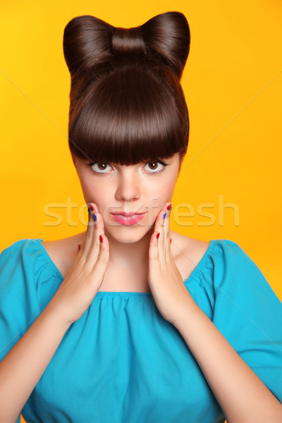 Surprised smiling teen girl with bow hairstyle, makeup and colou Stock photo © Victoria_Andreas