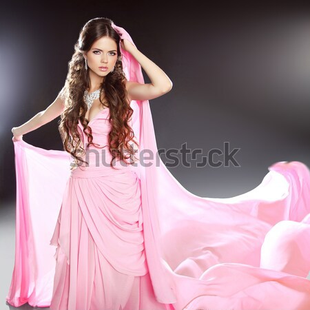 Beautiful Lady in luxury lush pink dress. Fashion brunette woman Stock photo © Victoria_Andreas
