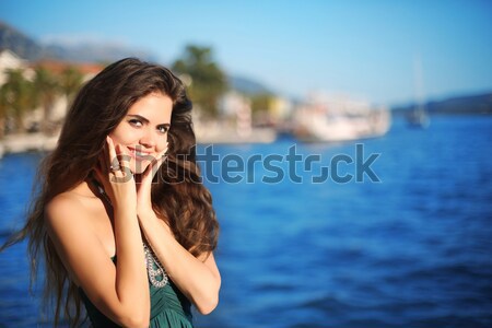 Portrait of happy smiling brunette woman with long wavy hair thi Stock photo © Victoria_Andreas