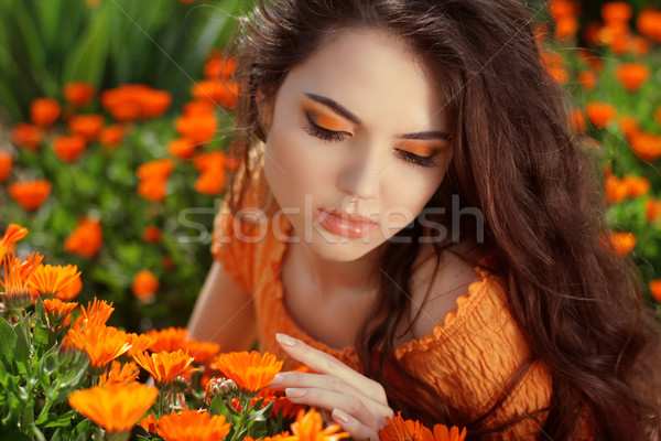 Young woman outdoors portrait over orange marigold flowers Stock photo © Victoria_Andreas