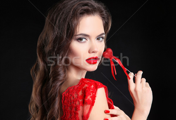 Red lips. Beautiful brunette girl portrait holding heart gift fo Stock photo © Victoria_Andreas