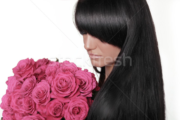 Brunette woman with fringe holding pink bouquet of roses isolate Stock photo © Victoria_Andreas
