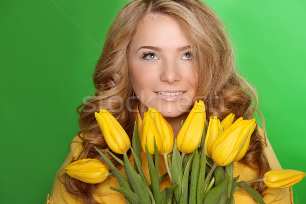 Happy smiling girl with spring-flower yellow tulips isolated on  Stock photo © Victoria_Andreas