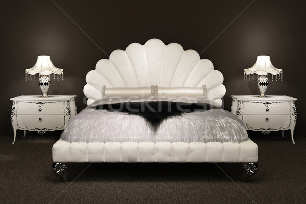 Modern bed with  furry bedspread and  lamp on thebedside table.  Stock photo © Victoria_Andreas
