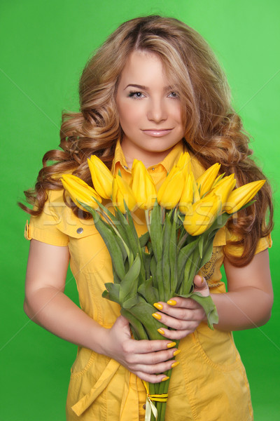 Beautiful Girl With Tulip Flowers over green background. Beauty  Stock photo © Victoria_Andreas