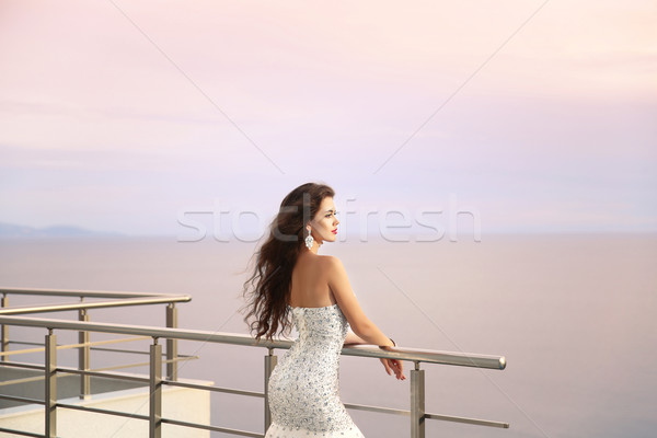 Stock photo: Beautiful bride girl in beaded wedding dress. Summer holiday fas