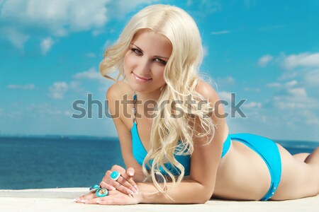 Happy smiling attractive blond woman over blue water swimming po Stock photo © Victoria_Andreas