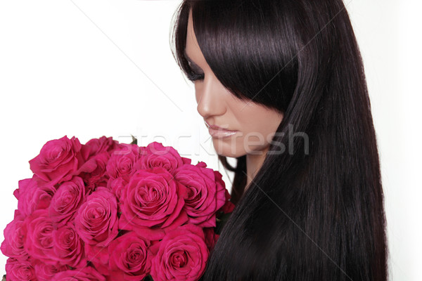 Healthy long hair. Brunette woman with fringe holding pink bouqu Stock photo © Victoria_Andreas