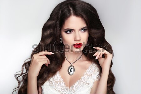 Beautiful Brunette Girl with red lips and nail manicure isolated Stock photo © Victoria_Andreas