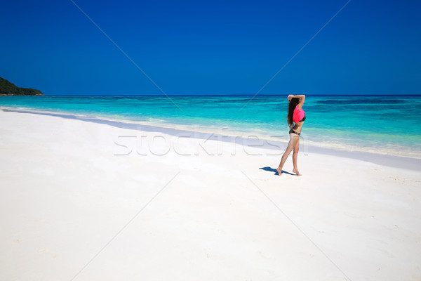 Enjoying life. Healthy woman walking on exotic sea. Fit brunette Stock photo © Victoria_Andreas