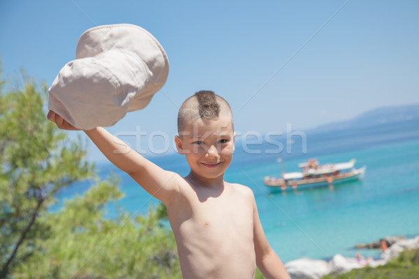 Boy Waving Hat Sea Shore Stock photo © vilevi