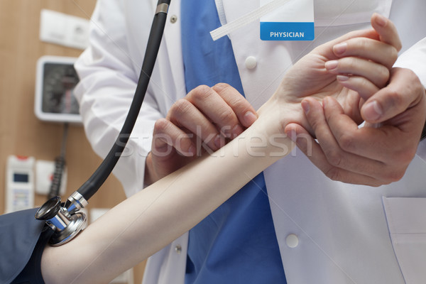 Stock photo: Doctor measuring pulse patient