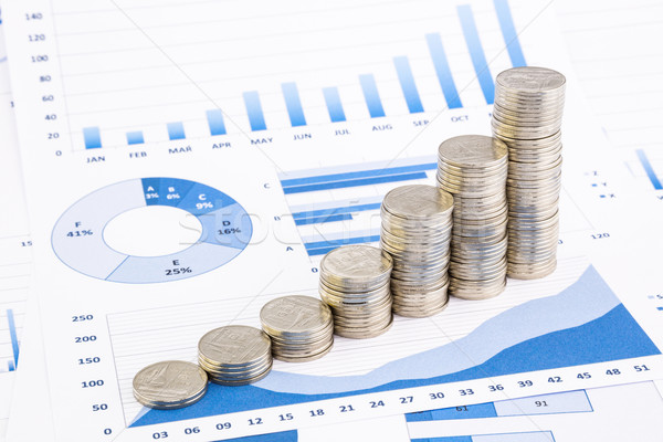 stacks of coins on  graphs and charts  Stock photo © vinnstock