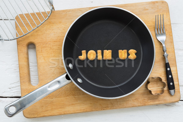 Letter cookies word JOIN US and kitchen utensils Stock photo © vinnstock