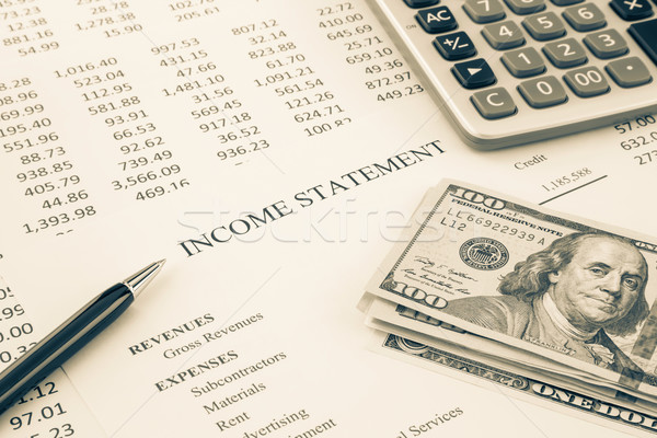 Money and income statement report in sepia tone Stock photo © vinnstock