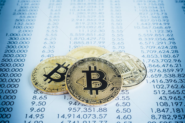 Bitcoins cryptocurrency on transaction reports, blue filter.  Stock photo © vinnstock