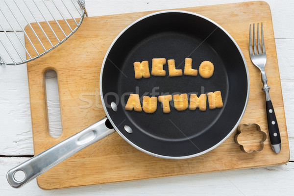 Stock photo: Cookie biscuits word HELLO AUTUMN in frying pan