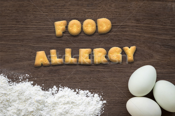 Letter biscuits word FOOD ALLERGY on kitchen table background Stock photo © vinnstock