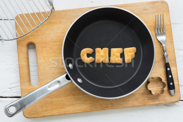 Alphabet crackers word CHEF putting in pan Stock photo © vinnstock