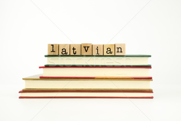 latvian language word on wood stamps and books Stock photo © vinnstock