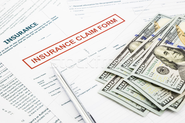 insurance claim form and money Stock photo © vinnstock