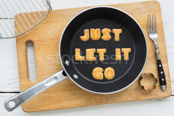 Letter cookies quote JUST LET IT GO and kitchen utensils Stock photo © vinnstock