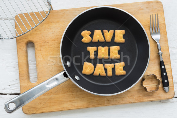 Stock photo: Letter biscuits quote SAVE THE DATE and cooking equipments.