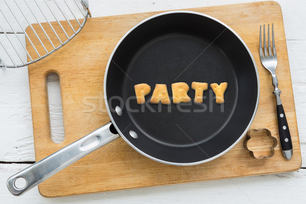 Cookie biscuits word PARTY in frying pan Stock photo © vinnstock