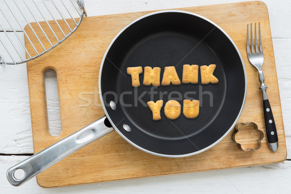 Cookie biscuits word THANK YOU in frying pan Stock photo © vinnstock