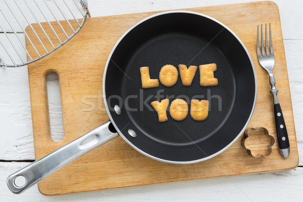 Letter cookies word LOVE YOU and kitchen utensils Stock photo © vinnstock