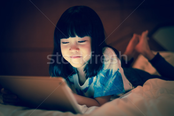 Kid using tablet online communicate social network. Stock photo © vinnstock