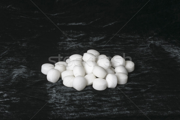 White naphthalene balls on black velvet Stock photo © vinodpillai