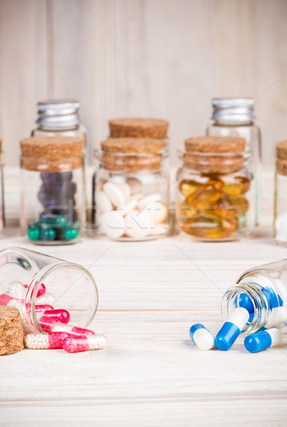 Blue and pink capsules in glass containers  Stock photo © viperfzk