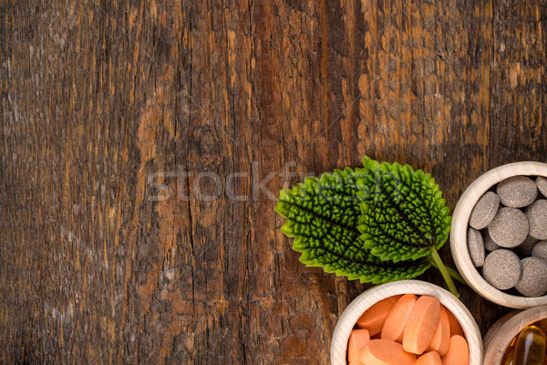 Various homeopathic medicine in wooden containers Stock photo © viperfzk